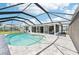 Inviting in-ground pool surrounded by a screened enclosure and brick paver deck at 5194 Cooper Ter, Port Charlotte, FL 33981