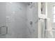 Sleek shower with modern fixtures, marble-look tile, and a glass door, providing a spa-like experience at 5194 Cooper Ter, Port Charlotte, FL 33981