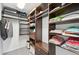 Well-organized walk-in closet features custom shelving, drawers, and ample space for storage and hanging clothes at 5194 Cooper Ter, Port Charlotte, FL 33981