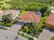 Stunning aerial view of home showcasing tile roof, landscaping and pool at 5428 Royal Poinciana Way, North Port, FL 34291