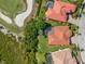 An aerial view of a luxurious home that features a screened in pool and close proximity to a pristine golf course at 5428 Royal Poinciana Way, North Port, FL 34291