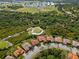 An aerial view of a residential area next to a golf course with greenery and sports complex at 5428 Royal Poinciana Way, North Port, FL 34291