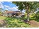 Expansive backyard featuring a covered lanai and plenty of green space at 5428 Royal Poinciana Way, North Port, FL 34291