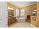 Bright bathroom features a large tub, a walk-in shower, and granite countertops at 5428 Royal Poinciana Way, North Port, FL 34291
