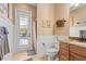 Bathroom with white beadboard, shower, and granite countertops with a door leading to the pool at 5428 Royal Poinciana Way, North Port, FL 34291