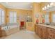 Bright bathroom features a large tub, a walk-in shower, and granite countertops at 5428 Royal Poinciana Way, North Port, FL 34291