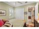 Cozy bedroom showcasing a ceiling fan, shutters, and a double door closet at 5428 Royal Poinciana Way, North Port, FL 34291