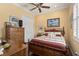 Cozy bedroom with hardwood floors, a wooden bed frame, and a dresser, offering a relaxing retreat at 5428 Royal Poinciana Way, North Port, FL 34291