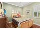 Charming bedroom with wood floors, shutters, ceiling fan, and neutral decor at 5428 Royal Poinciana Way, North Port, FL 34291