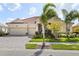 Attractive one-story home with three-car garage, red tile roof, paved brick driveway, and well-maintained landscaping at 5428 Royal Poinciana Way, North Port, FL 34291