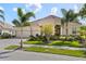 Lovely single-story home with three-car garage, paved driveway, red tile roof, and mature landscaping at 5428 Royal Poinciana Way, North Port, FL 34291
