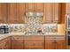 Kitchen features stainless steel appliances, granite countertops, and a decorative backsplash at 5428 Royal Poinciana Way, North Port, FL 34291