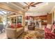 Open floor plan with living room flowing into the kitchen, featuring ample seating and natural light at 5428 Royal Poinciana Way, North Port, FL 34291