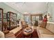 Well-decorated living room featuring neutral colors, comfortable seating, and open access to the dining area at 5428 Royal Poinciana Way, North Port, FL 34291
