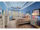 Serene main bedroom with blue walls, neutral trim, and a comfortable bed at 5428 Royal Poinciana Way, North Port, FL 34291