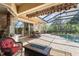 Charming outdoor patio with screened-in pool, spa, dining area, and fire pit at 5428 Royal Poinciana Way, North Port, FL 34291