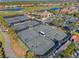 Overhead view of the community tennis courts with a view of the pool and clubhouse beyond at 5428 Royal Poinciana Way, North Port, FL 34291