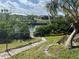 Landscaped backyard featuring a canal view and dock, perfect for relaxing by the water at 705 Crestview Nw Cir, Port Charlotte, FL 33948