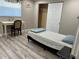 Cozy bedroom with modern floors, a desk, a closet, and a comfortable bed with gray and white patterned comforter at 705 Crestview Nw Cir, Port Charlotte, FL 33948