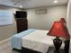 Bedroom featuring laminate wood flooring, a large bed and dresser at 705 Crestview Nw Cir, Port Charlotte, FL 33948