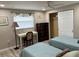 Well-lit bedroom with modern floors, a desk, closet, and comfortable beds with blue comforters at 705 Crestview Nw Cir, Port Charlotte, FL 33948