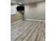 Empty bedroom featuring laminate wood flooring and a window at 705 Crestview Nw Cir, Port Charlotte, FL 33948