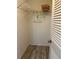 Small closet with laminate flooring, a shelf and a hanging rod at 705 Crestview Nw Cir, Port Charlotte, FL 33948