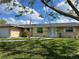 Charming home featuring well-maintained landscaping, a welcoming entrance, and a neatly manicured lawn at 705 Crestview Nw Cir, Port Charlotte, FL 33948