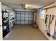 Organized garage with ample storage space, shelving units, and garage door at 705 Crestview Nw Cir, Port Charlotte, FL 33948