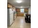 Bright kitchen with tile floors, light wood cabinets and all-white appliances at 705 Crestview Nw Cir, Port Charlotte, FL 33948