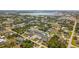 Expansive aerial view of a residential neighborhood with single-Gathering homes and lush green landscaping near a beautiful lake at 7434 Ashtabula St, Englewood, FL 34224