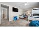 Spacious bedroom with tiled floors, a TV, storage cubbies, and a nautical theme at 7434 Ashtabula St, Englewood, FL 34224