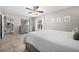 Bedroom with a dresser, neutral decor, a ceiling fan, and access to the kitchen at 7434 Ashtabula St, Englewood, FL 34224