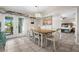 The dining room showcases white wooden chairs, a chandelier, and direct access to the bedroom at 7434 Ashtabula St, Englewood, FL 34224