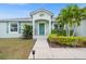 Charming one-story home with a beautifully landscaped front yard and vibrant green shutters at 7434 Ashtabula St, Englewood, FL 34224