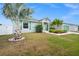 Inviting one-story home with well-maintained landscaping, lush plants, and a welcoming entrance at 7434 Ashtabula St, Englewood, FL 34224
