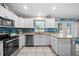 Bright kitchen with stainless steel appliances, white cabinets, and granite countertops at 7434 Ashtabula St, Englewood, FL 34224