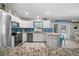 Bright kitchen with stainless steel appliances, white cabinets, and granite countertops at 7434 Ashtabula St, Englewood, FL 34224