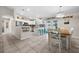 Open kitchen boasts an island with barstool seating, granite countertops, and white cabinetry at 7434 Ashtabula St, Englewood, FL 34224