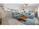Inviting living room featuring comfortable blue sofas, tile floors, and an open layout at 7434 Ashtabula St, Englewood, FL 34224