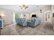 Bright living room features tile floors, a ceiling fan, light blue couches and a large window at 7434 Ashtabula St, Englewood, FL 34224