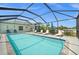 Beautiful screened-in pool with lounge chairs, perfect for outdoor relaxation and entertaining at 7434 Ashtabula St, Englewood, FL 34224