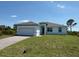 Beautiful single-story home with a well-maintained lawn and a two-car garage at 7474 Manville Ter, Port Charlotte, FL 33981