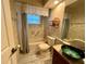 Classic bathroom featuring wood-look flooring, a vessel sink, a shower/tub combo, and traditional fixtures at 1305 Alton Rd, Port Charlotte, FL 33952