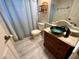 Quaint bathroom with a unique vanity, vessel sink, wood-look flooring, and a classic toilet at 1305 Alton Rd, Port Charlotte, FL 33952
