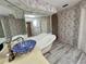 Bathroom displaying a standalone tub, designer sink, and stylish floral wallpaper at 1305 Alton Rd, Port Charlotte, FL 33952