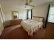 Inviting bedroom featuring carpeting, bright natural light, a ceiling fan, and ample space for comfortable living at 1305 Alton Rd, Port Charlotte, FL 33952