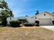 Charming home featuring brick pathway, landscaping, unique archway and a one-car garage at 1305 Alton Rd, Port Charlotte, FL 33952
