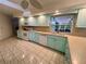 Spacious kitchen featuring bright cabinetry, white appliances, tiled flooring, and generous countertop space at 1305 Alton Rd, Port Charlotte, FL 33952