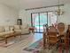 Cozy living space with dining area, offering seamless transition to outdoor living and pool area at 1305 Alton Rd, Port Charlotte, FL 33952